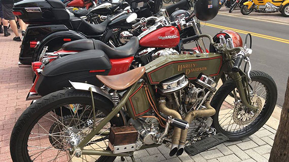 A patriotic themed motorcycle in front of row of motorcylces