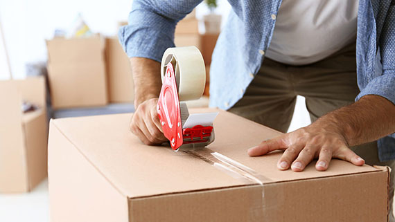 Two men moving a couch out of a van