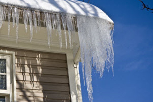 icicles hanging off the eaves of a roof