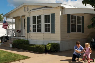 A mobile home with children playing out front