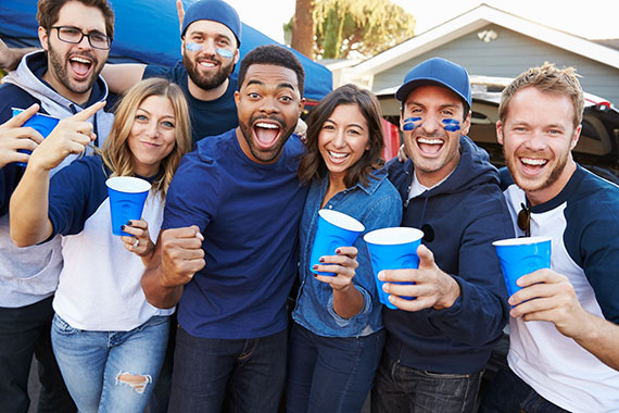 A group of people enjoying a tailgate party at the game